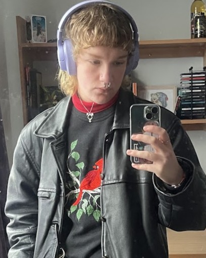 man with dirty blond medium length hair in black clothing