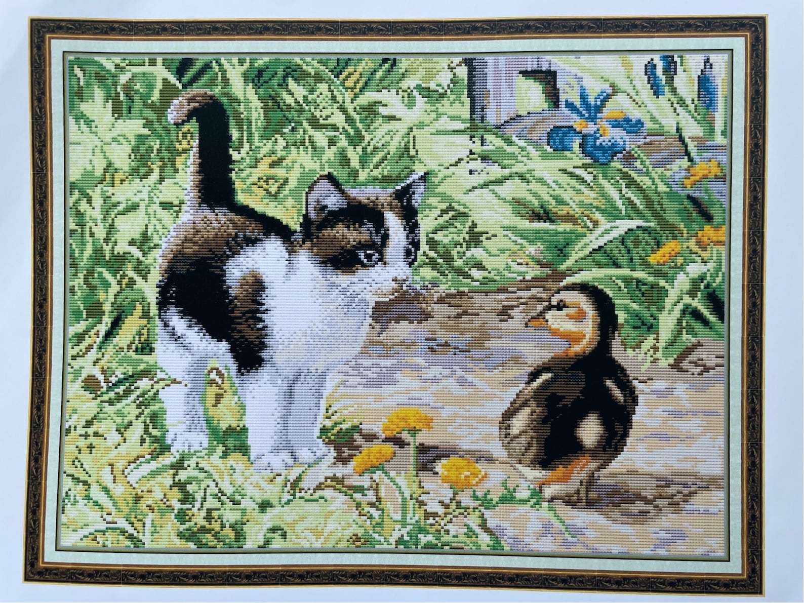 pixelated image of a kitten and gosling amongst a path and bushes