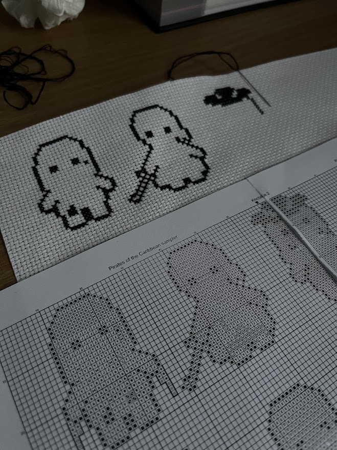 cross stitch versions of Jack Sparrow and Will Turner