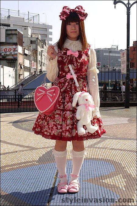 A sweet Lolita wearing a red floral dress