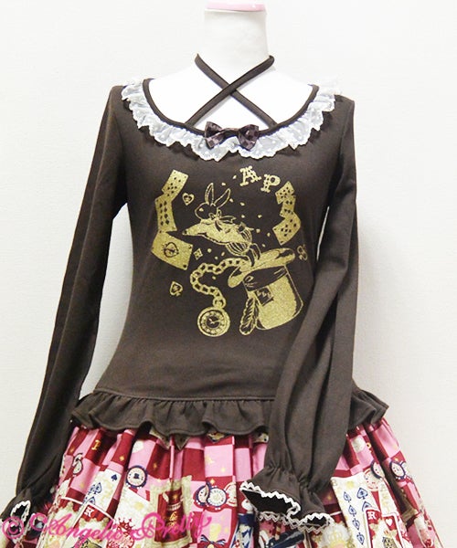 Brown long sleeve top with a gold alice in wonderland print